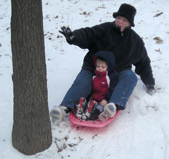 Sledding on the back hill. Watch out for that tree!